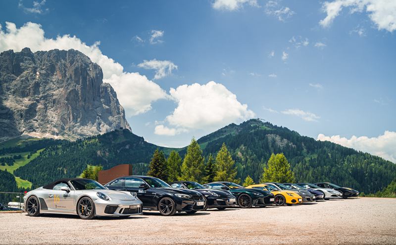 Supercars lined up below the Dolomites