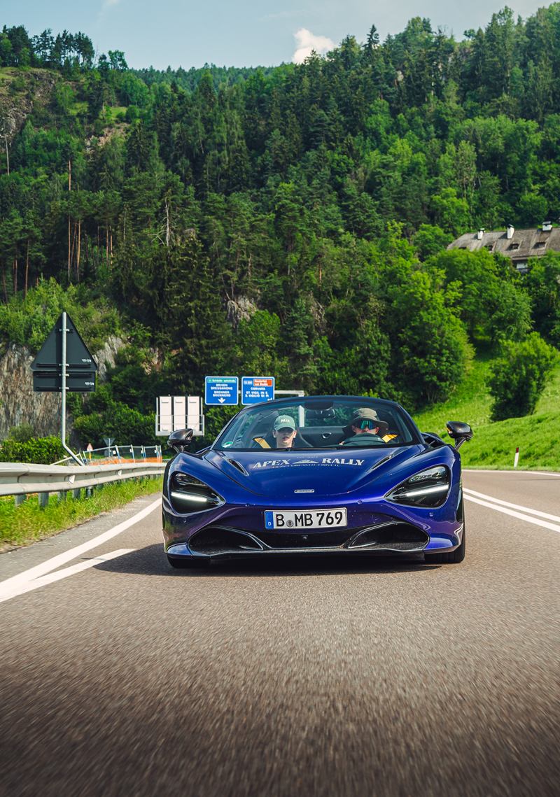 Blue McLaren on an alpine road