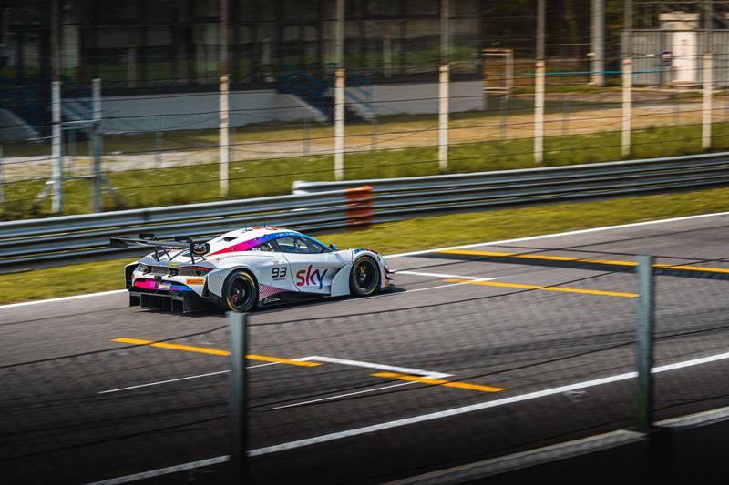 White GT race car at speed on the track