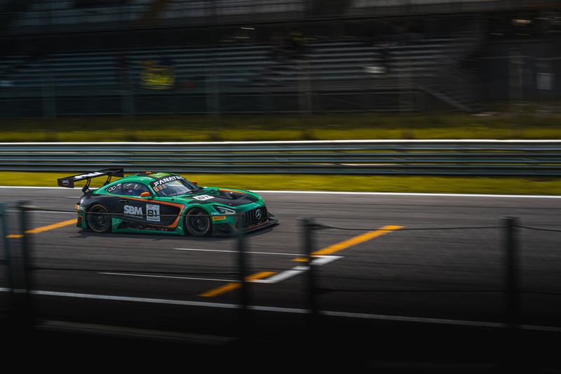 GT3 race car in green and black livery on the track