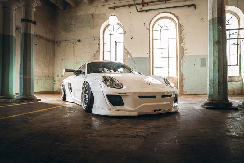 White widebody Porsche in an old industrial hall