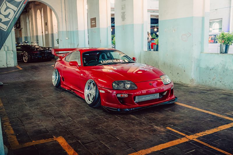 Red Toyota Supra in an old industrial hall