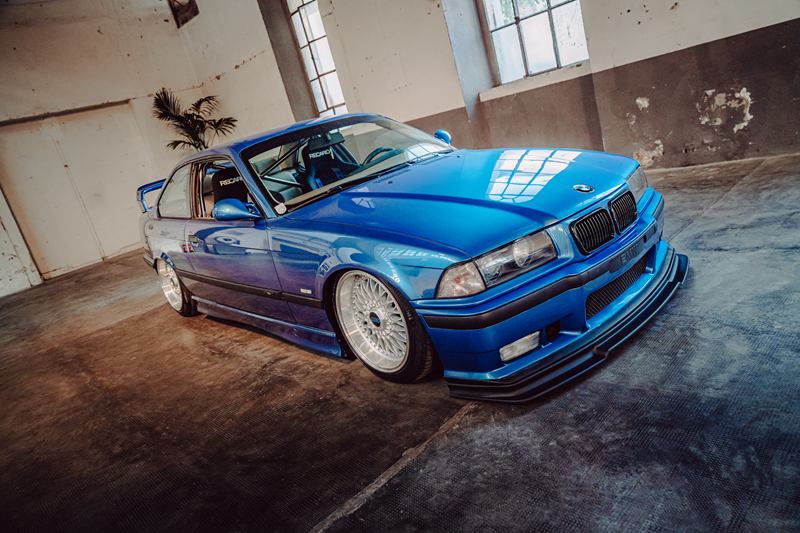 Blue BMW M3 E36 in an old industrial hall