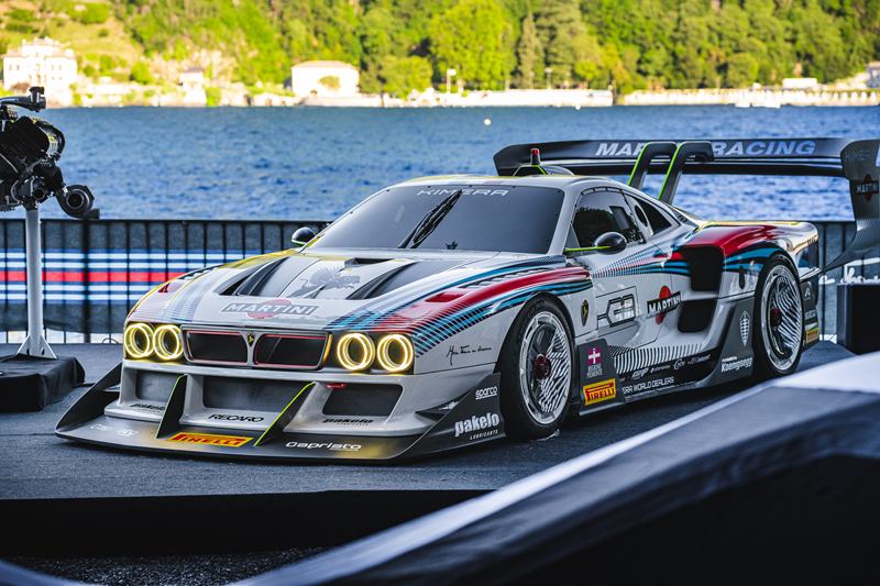 Race car in Martini livery on display by a lake