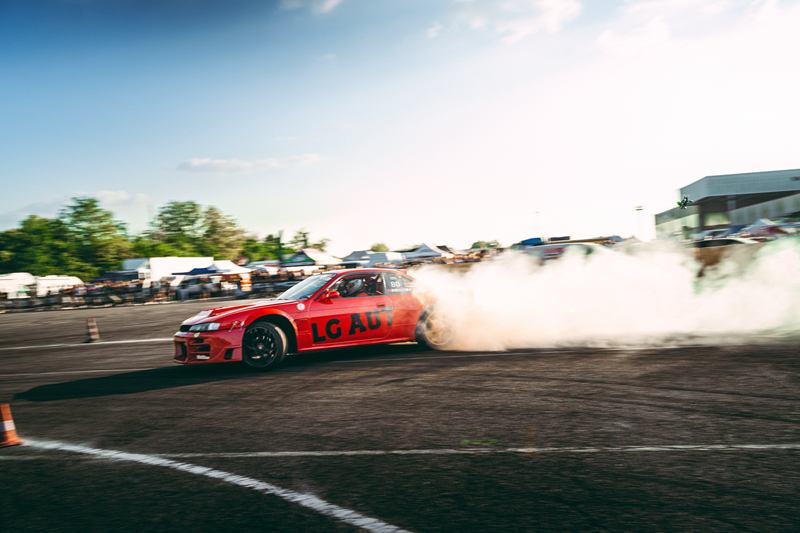 Red Nissan Silvia drifting in a cloud of tyre smoke