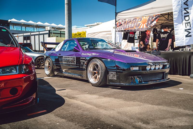 Purple and black Mazda RX-7 drift car at an event
